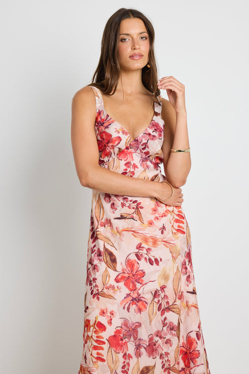 Model wears a strappy floral blush maxi dress