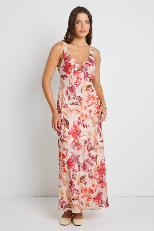 Model wears a strappy floral blush maxi dress