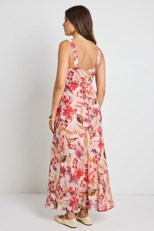 Model wears a strappy floral blush maxi dress