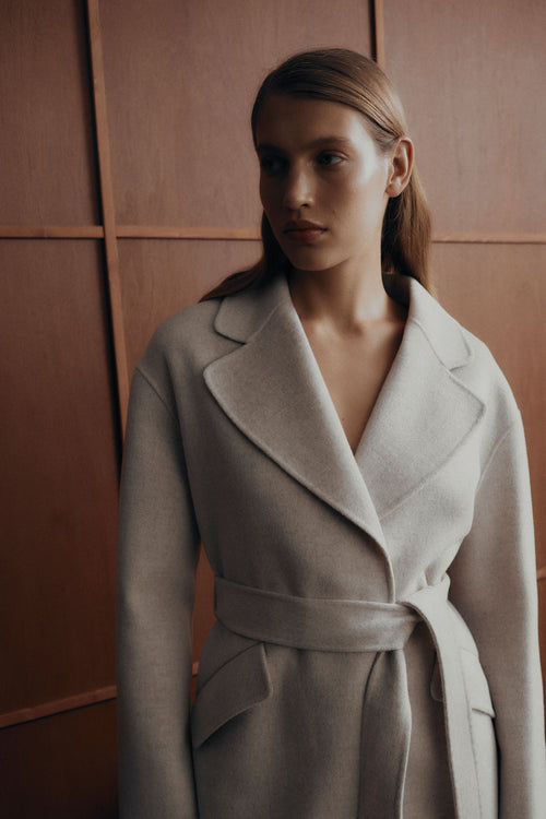 model wears a white coat