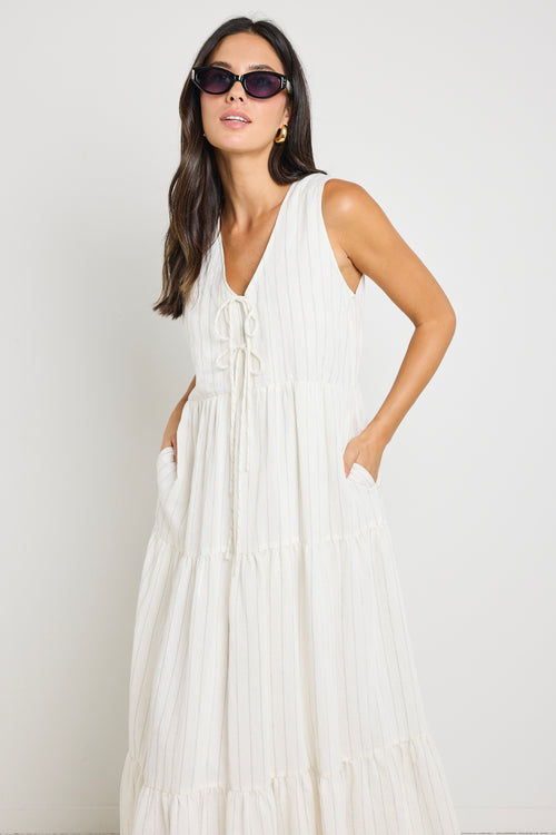 model wears a white stripe maxi dress