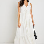 model wears a white stripe maxi dress