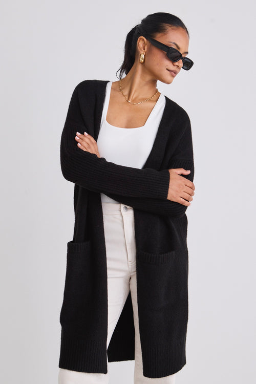 model wears a black cardigan