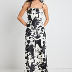 model wears a black and white maxi dress