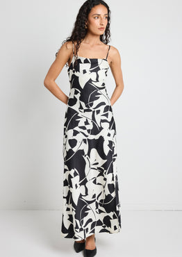 model wears a black and white maxi dress