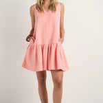 model wears a pink linen mini dress