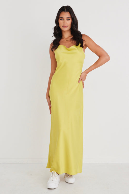 model wears a yellow satin strappy maxi dress