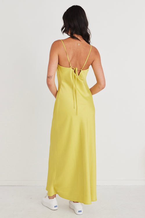 model wears a yellow satin strappy maxi dress