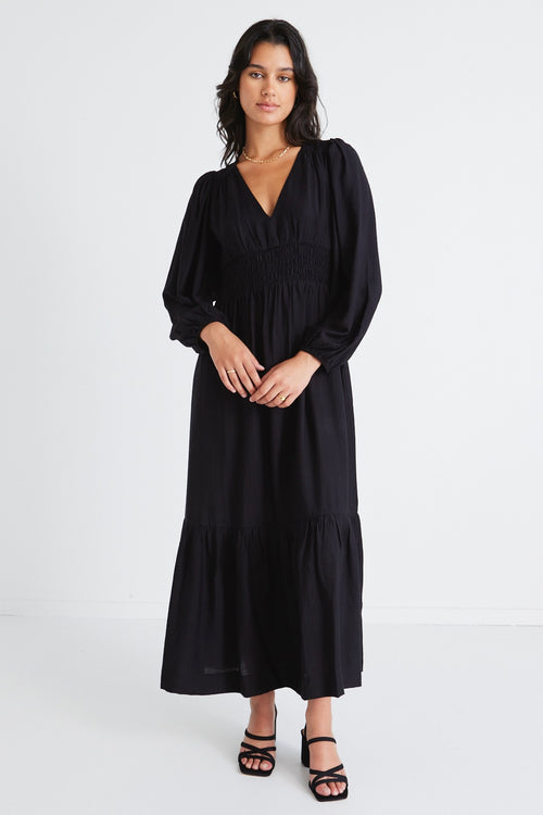 model wears a black maxi dress