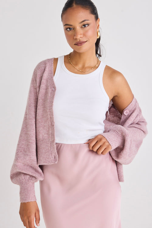 model wears a pink cardigan