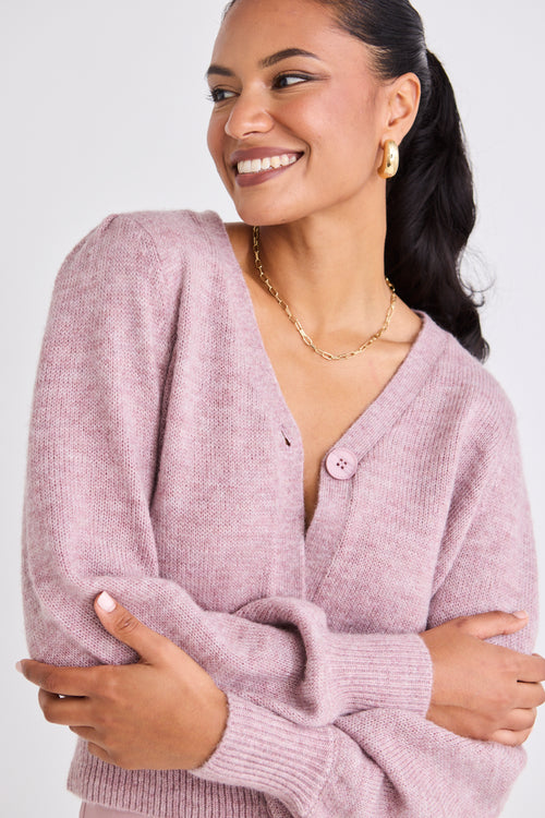 model wears a pink cardigan