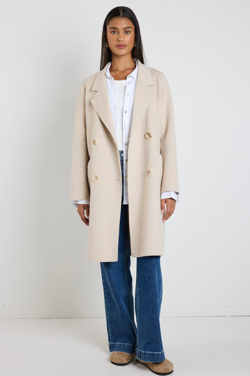 model wears a beige wool coat