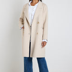 model wears a beige coat