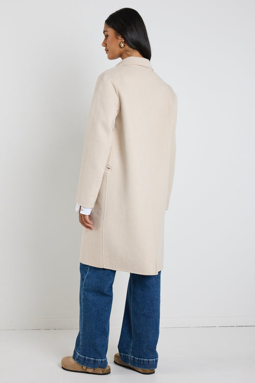 model wears a beige wool coat