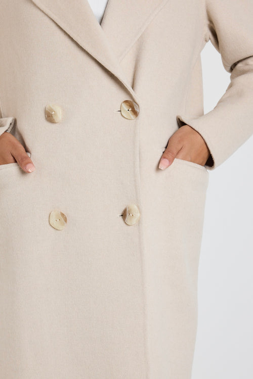 model wears a beige wool coat
