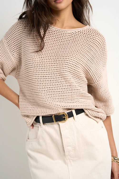 model wears a beige knit t shirt