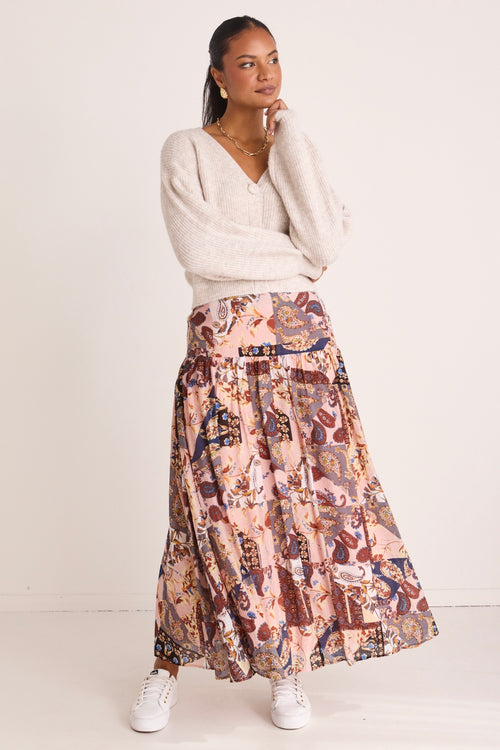 model wears a pink floral maxi skirt