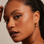 model wearing Thick Classic Gold Hoop Earrings