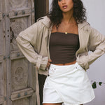 model wears taupe trench coat