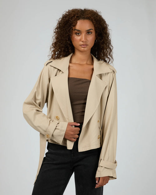 model wears taupe trench coat