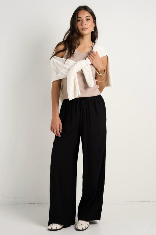 model wears black wide leg pants