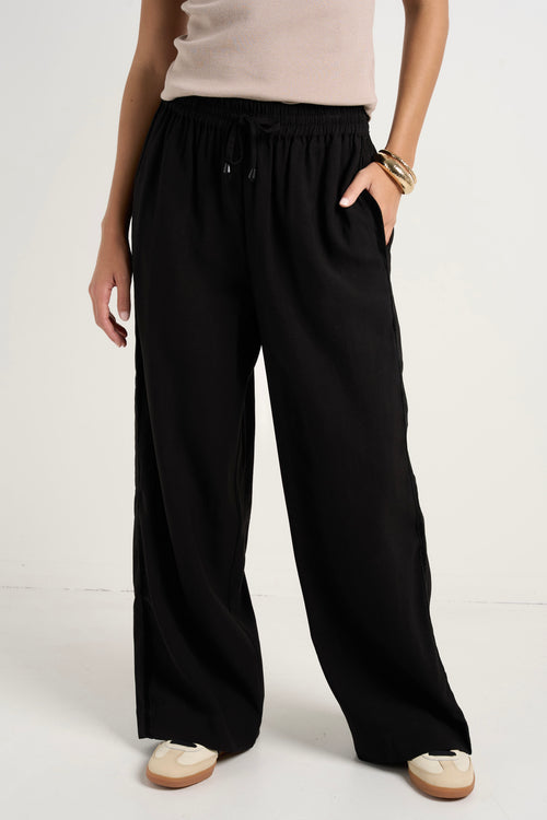 model wears black wide leg pants