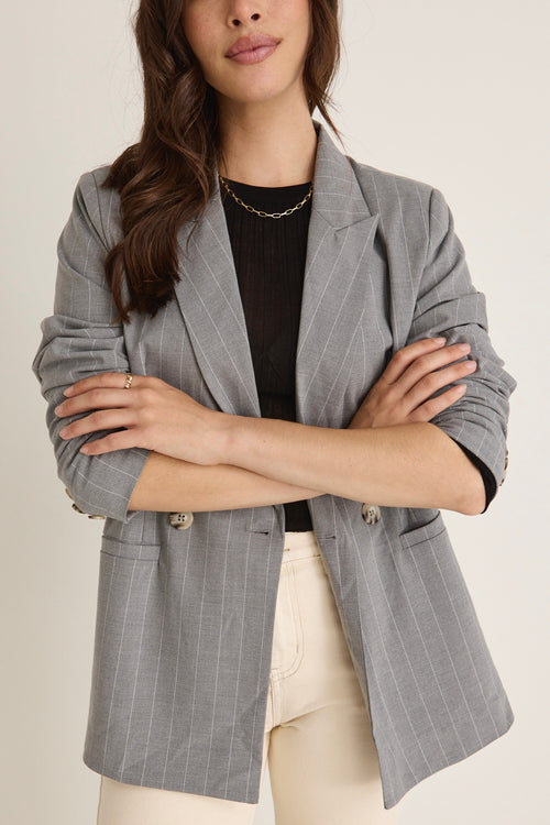 model wears a grey blazer