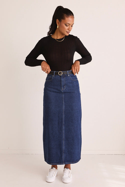 model wears a blue denim maxi skirt