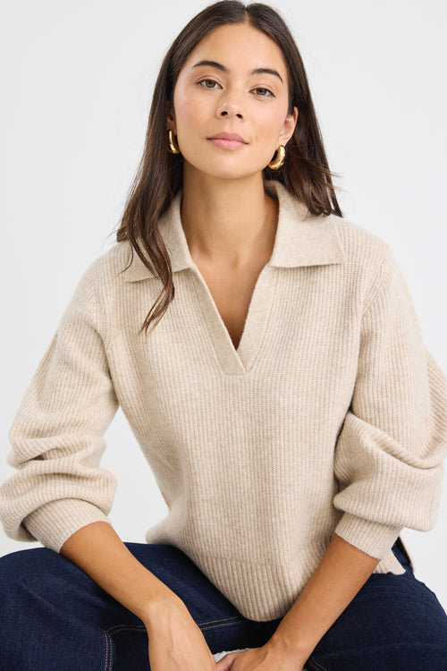 Model wears a beige knit collared jumper