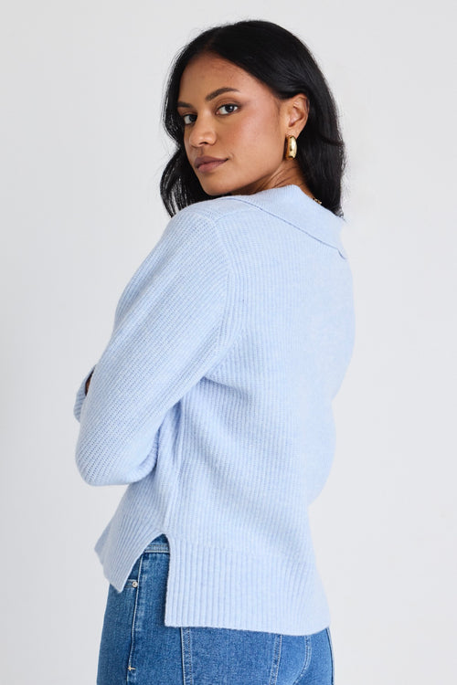 model wears a blue knit jumper