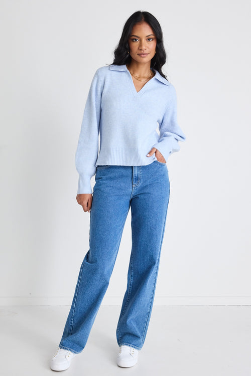 model wears light blue jumper and blue jeans