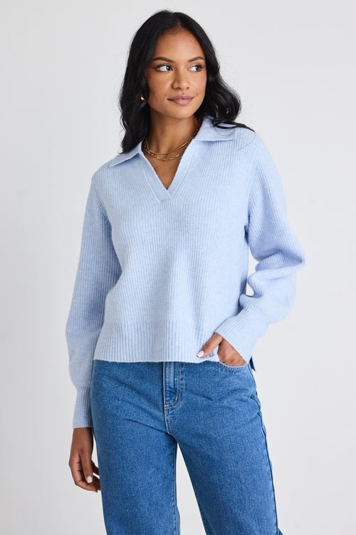 model wears light blue jumper and blue jeans