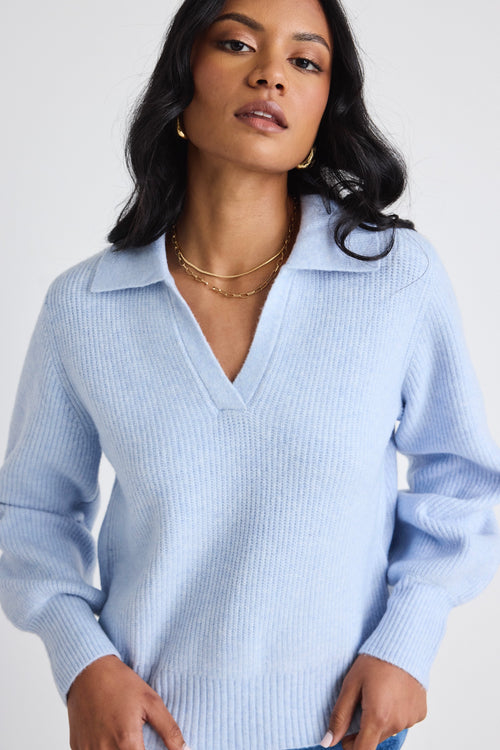 model wears a blue knit jumper