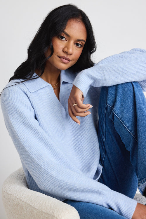 model wears light blue jumper and blue jeans