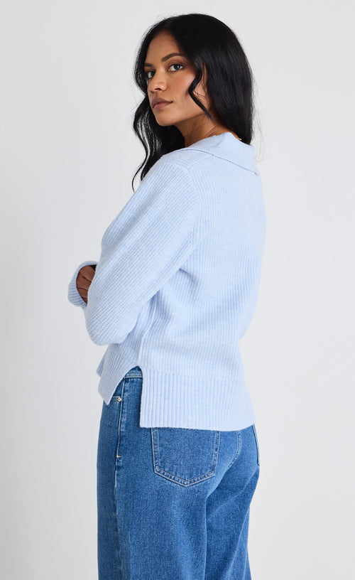 model wears light blue jumper and blue jeans