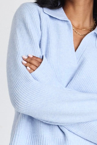 model wears light blue jumper and blue jeans
