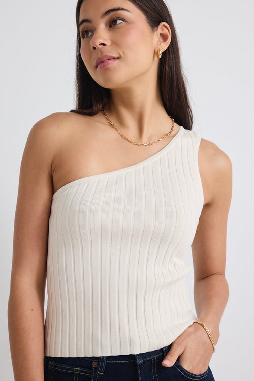 model wears a beige one shoulder top