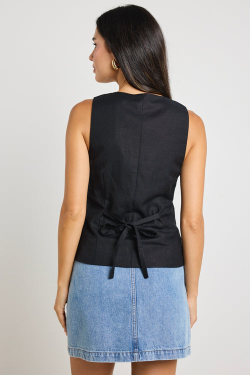 model wears a black linen vest