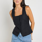 model wears a black linen vest