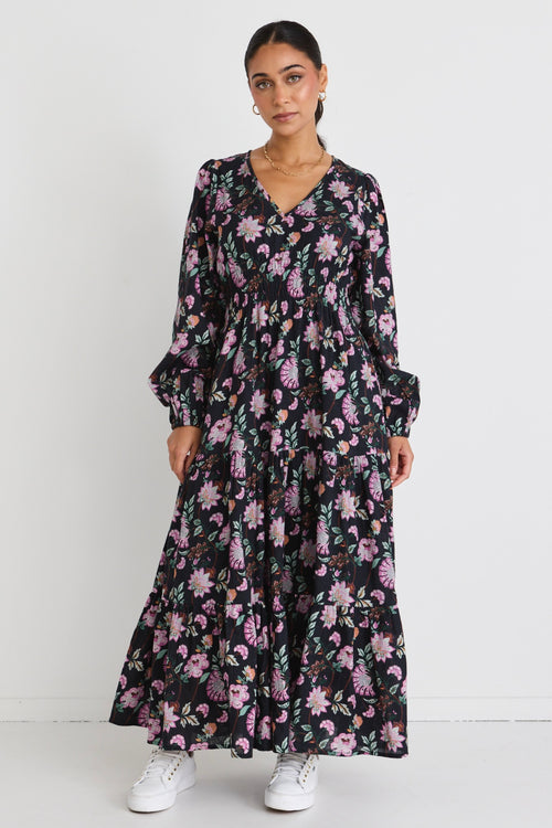 model wears a black floral maxi dress