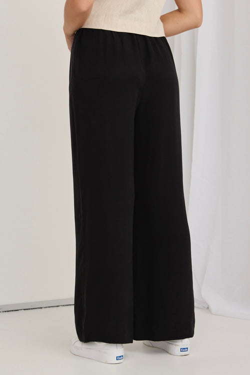 model wears black pants
