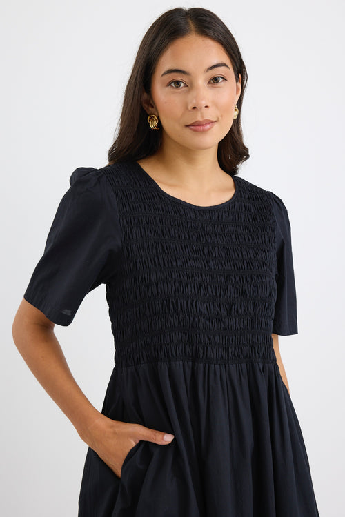 model wears a black linen maxi dress