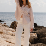 Model wears a stripe white and tan shirt 