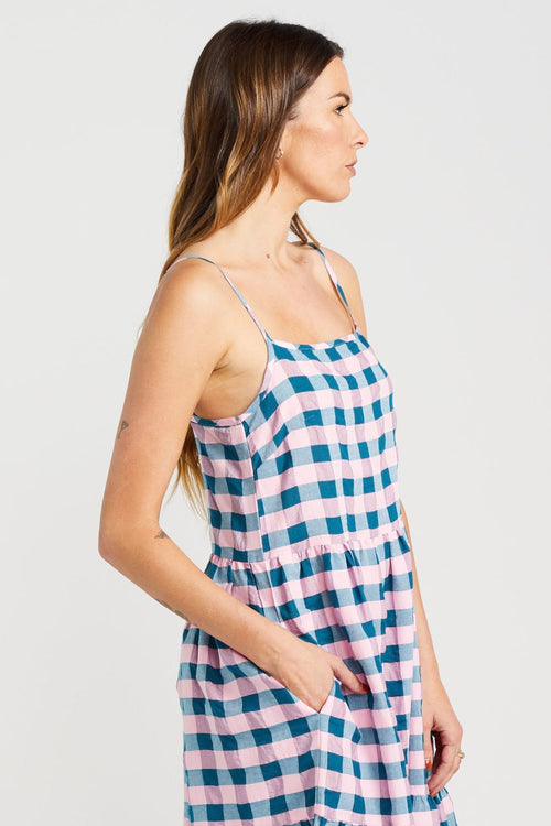 model wears blue and pink check maxi dress