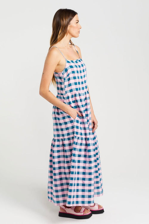 model wears blue and pink check maxi dress