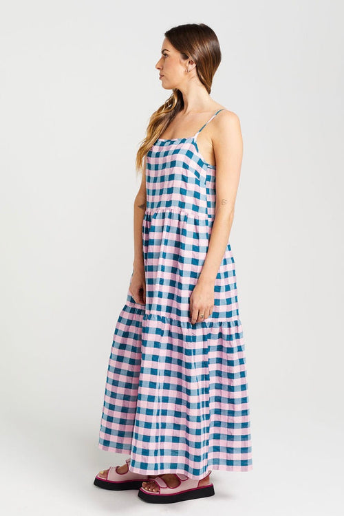 model wears blue and pink check maxi dress