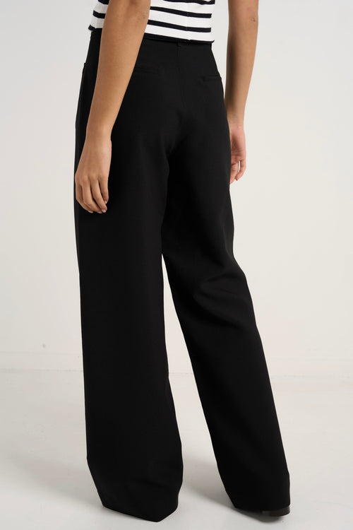 model wears black wide leg pants