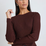 Model wears a brown long sleeve rounded neck ribbed top