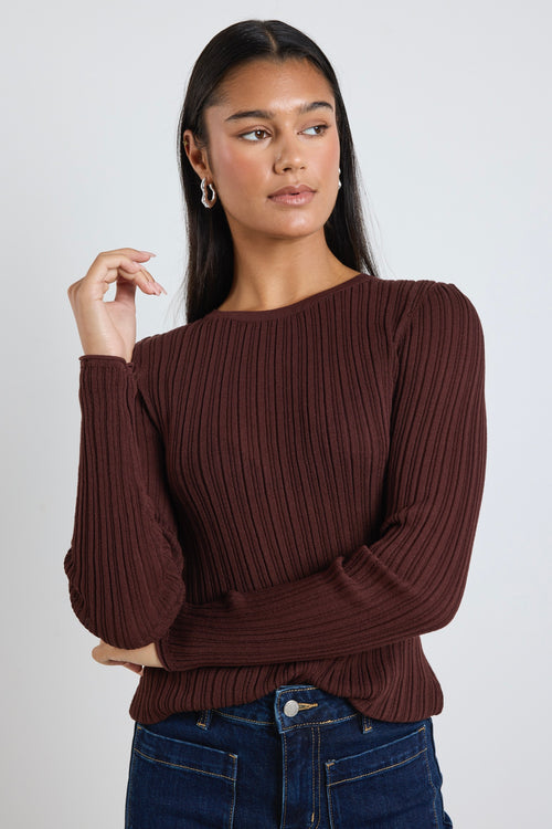 Model wears a brown long sleeve rounded neck ribbed top