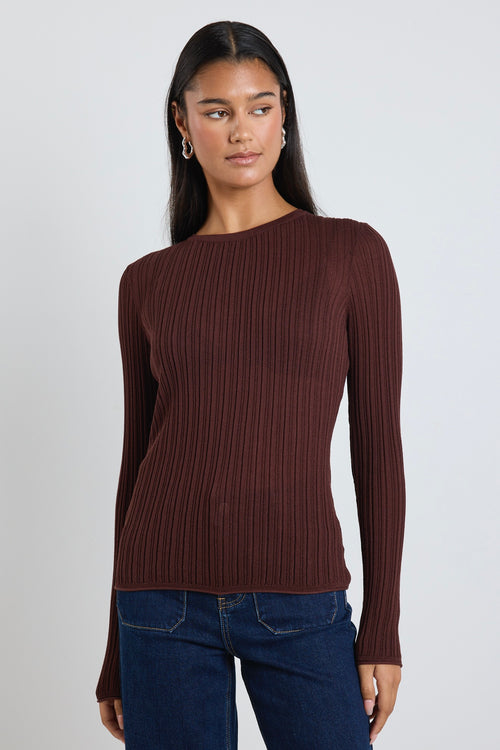 Model wears a brown long sleeve rounded neck ribbed top